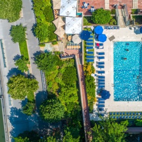 a drop-down view of a pool with trees and buildings