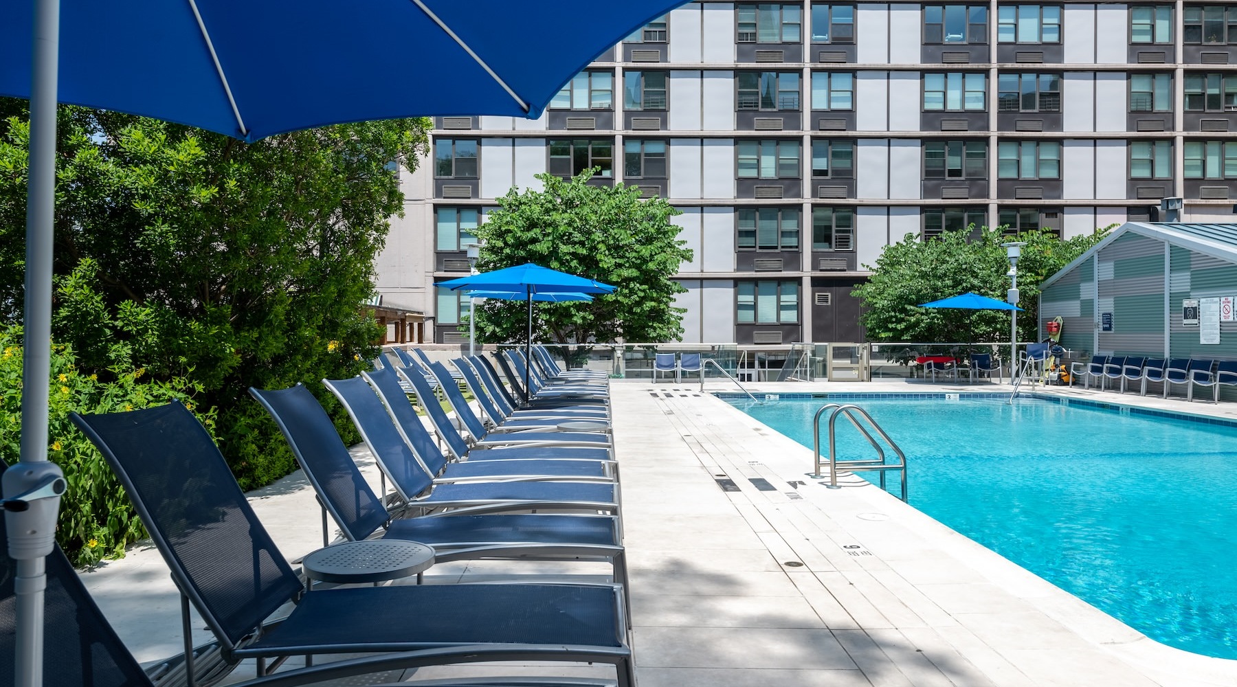 a swimming pool with lounge chairs