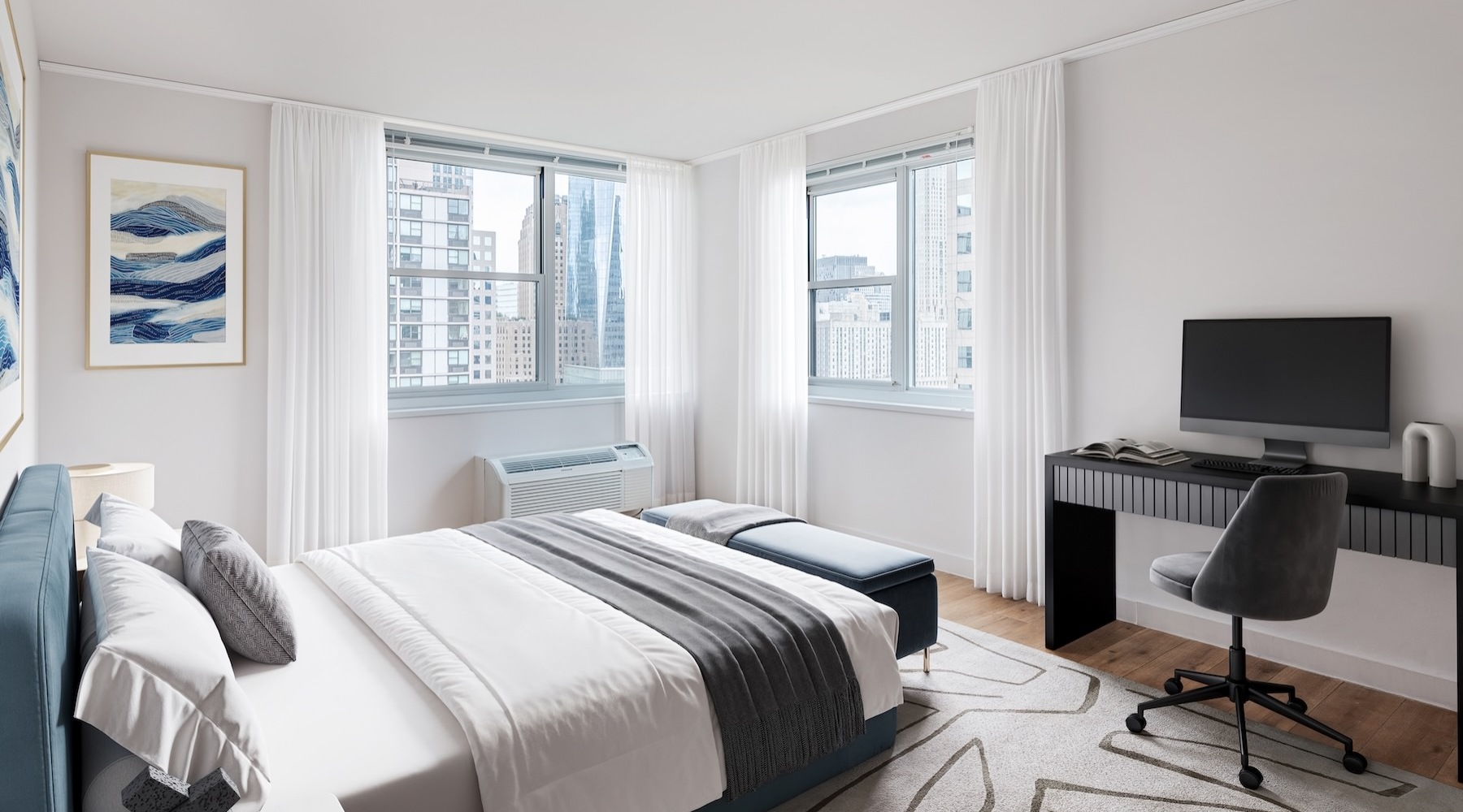 a bedroom with a bed, desk and a chair