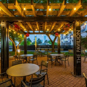 a covered patio with a table and chairs