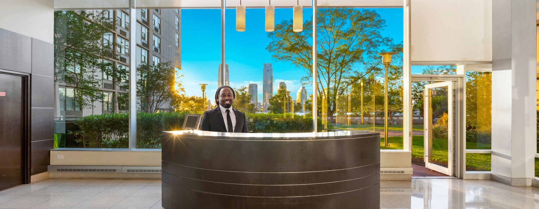 a front desk worker smiling