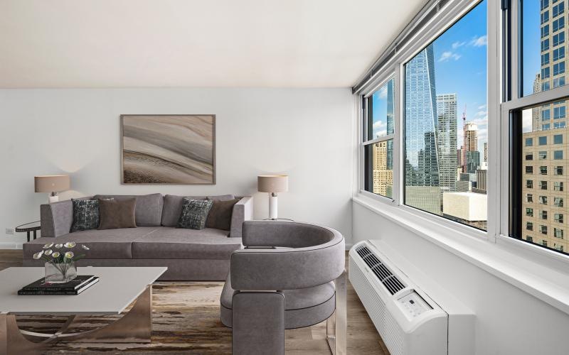 a living room with a couch, table and chair