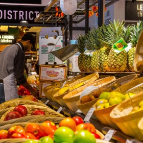 a person working at a stand with fruits